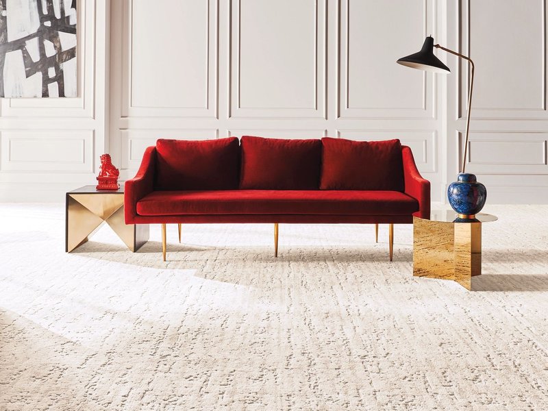 Red sofa on beige carpet from Carpet Studio & Design Inc. in Los Angeles, CA